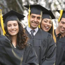 Graduate students standing in a row, outdoors