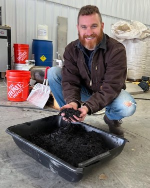 Andrew Jones, Carba's founder and CEO, holding a handful of biochar.