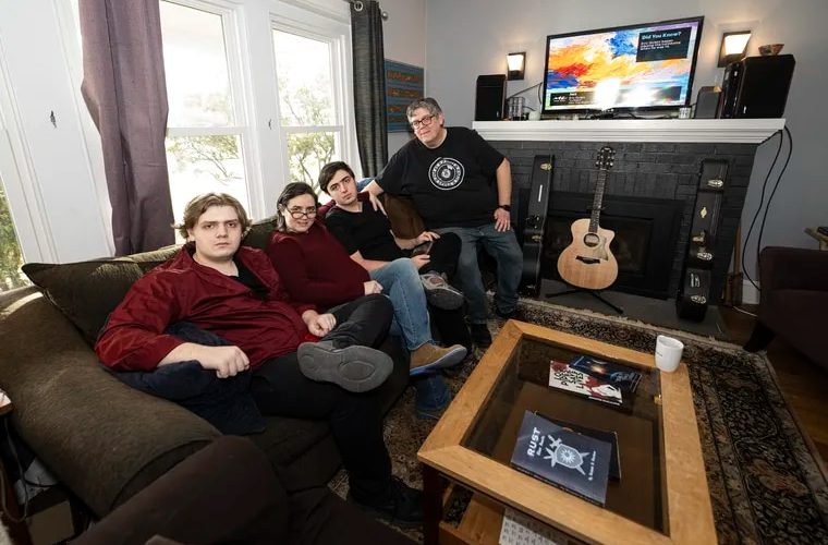 Pier and Jennifer Giacolone with their two sons, Ben (left) and Rolley in the living room of their home in Doylestown.
