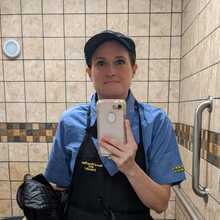 Amanda Claypool taking a selfie at Waffle House in her uniform.