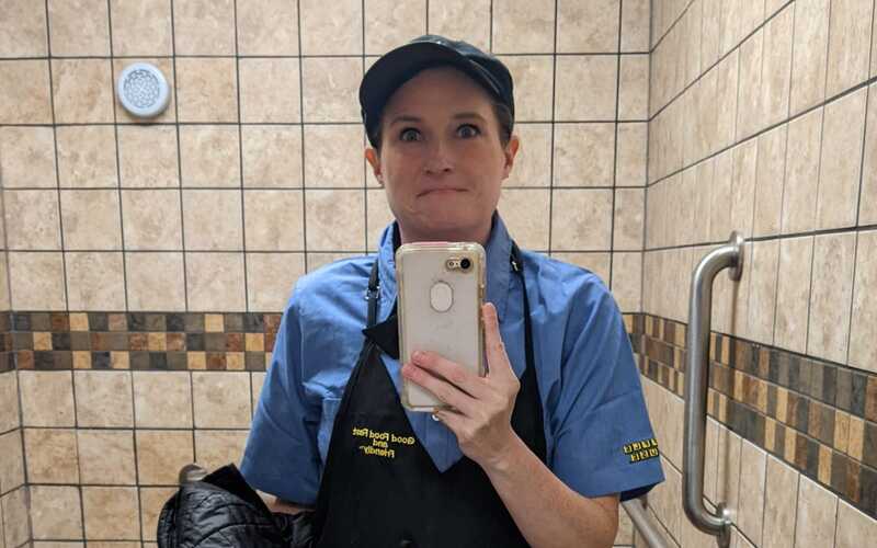 Amanda Claypool taking a selfie at Waffle House in her uniform.