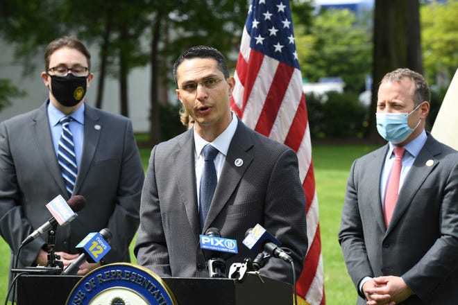 N.J. state Sen. Joseph Lagana talks about how New York City's congestion pricing will affect New Jersey commuters, in Paramus, N.J., on Monday May 10, 2021. In the background, from left, are N.J. Assemblyman Chris Tully and U.S. Rep. Josh Gottheimer.
